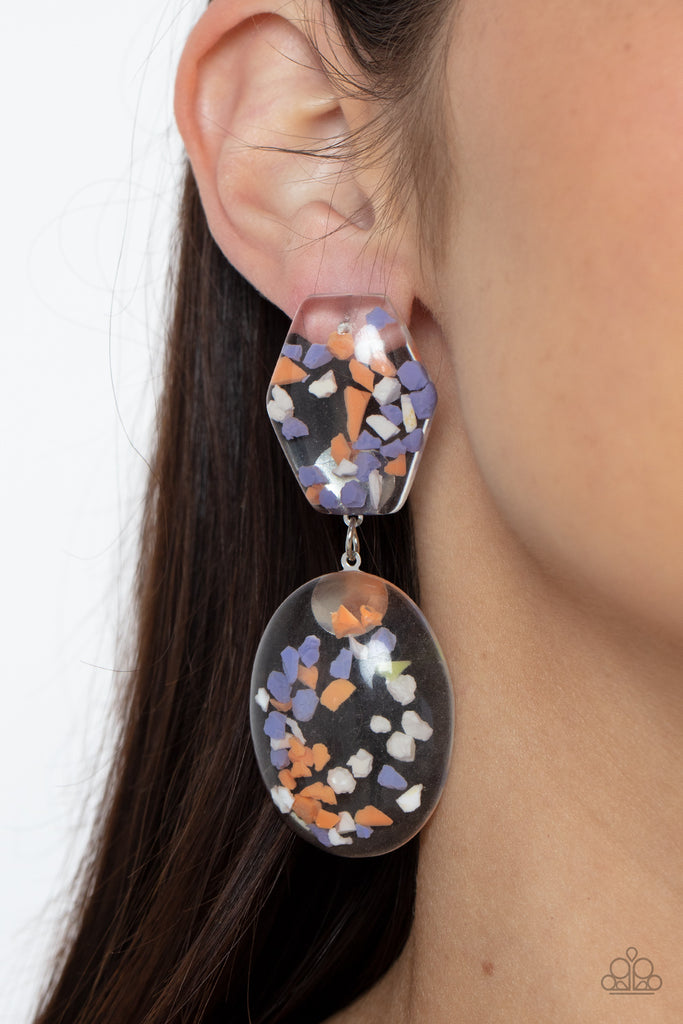 Featuring multicolored confetti-like flakes, a clear acrylic oval frame swings from the bottom of a matching hexagonal frame, creating a bubbly lure. Earring attaches to a standard post fitting.  Sold as one pair of post earrings.