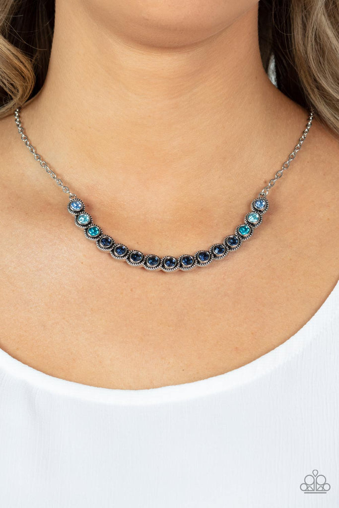 Encased in studded silver fittings, a glittery ombré of blue rhinestones delicately bows below the collar, creating an enchanting pop of color. Features an adjustable clasp closure.  Sold as one individual necklace. Includes one pair of matching earrings.