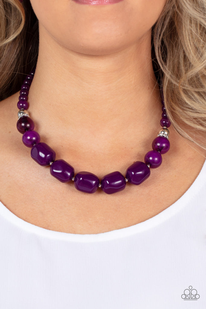 Accented with bright silver beads and glittery rhinestone accents, a row of oversized subtly faceted plum beads gives way to marbled plum beads that transition to smaller opaque plum beads as they make their way around the collar for a modern fashion. Features an adjustable clasp closure.  Sold as one individual necklace. Includes one pair of matching earrings.  