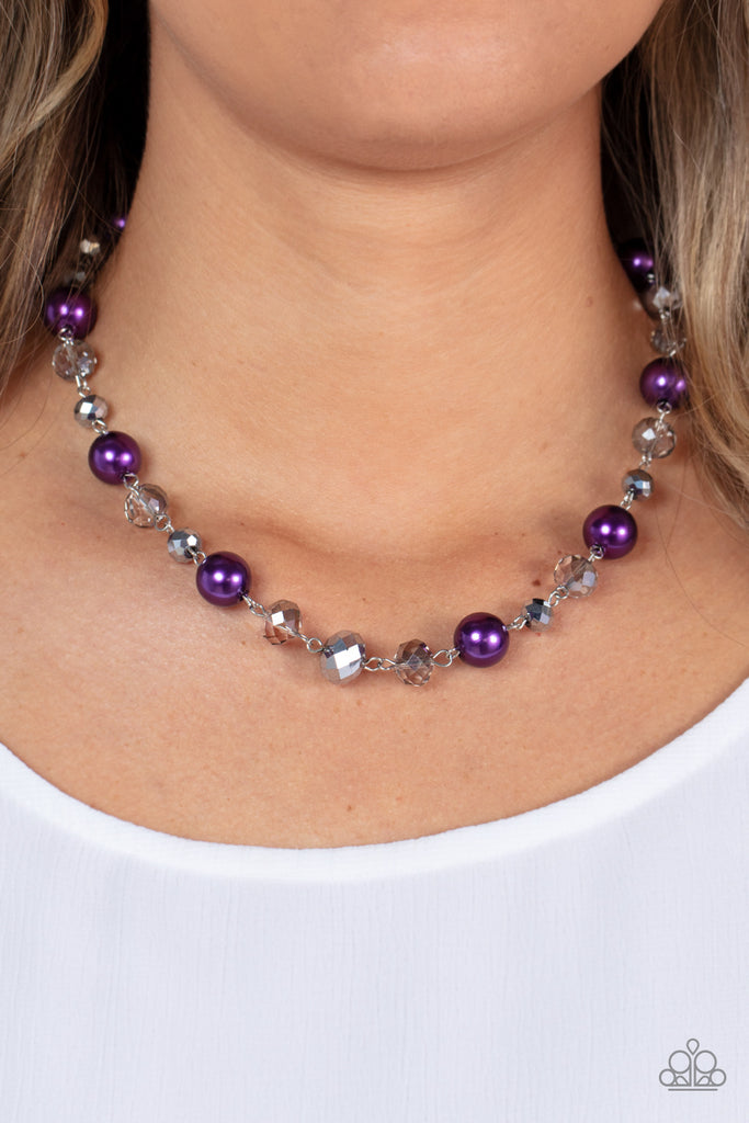 A glamorous collection of oversized pearly purple beads, metallic-flecked and smoky crystal-like beads delicately link below the collar, resulting in a glitzy pop of color. Features an adjustable clasp closure.  Sold as one individual necklace. Includes one pair of matching earrings.