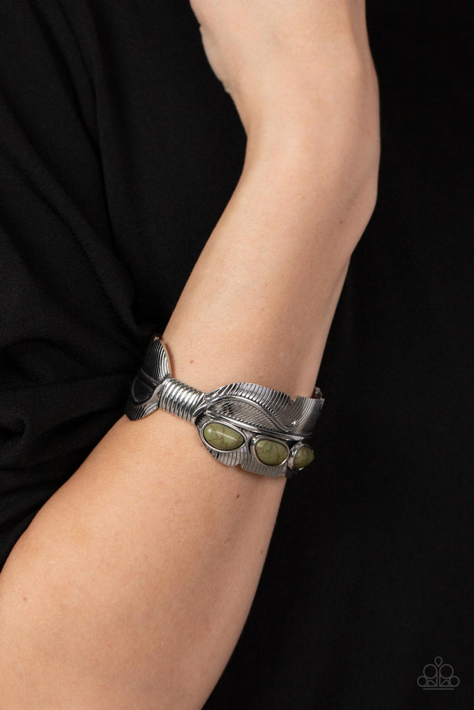A trio of asymmetrical Olive Branch stones embellishes the front of a lifelike textured silver feather that curls around the wrist, creating an authentic southwestern cuff.  Sold as one individual bracelet.
