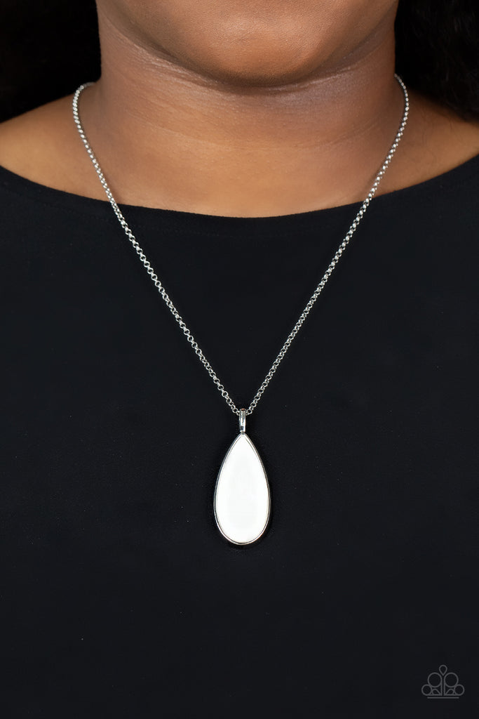 Encased in a sleek silver fitting, a white shell-like teardrop pendant swings from the bottom of an elegantly extended silver chain for a refined look. Features an adjustable clasp closure.  Sold as one individual necklace. Includes one pair of matching earrings.