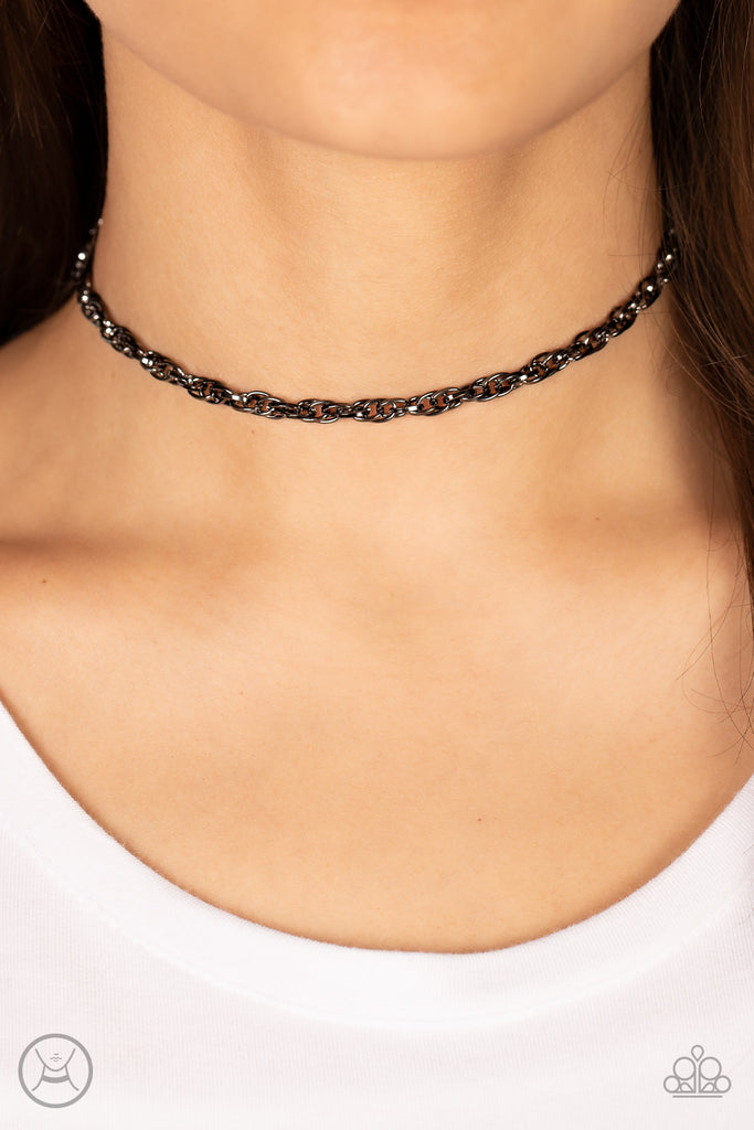 An ornately linked gunmetal chain wraps around the neck, resulting in an edgy minimalist inspired grit. Features an adjustable clasp closure.  Sold as one individual choker necklace. Includes one pair of matching earrings.