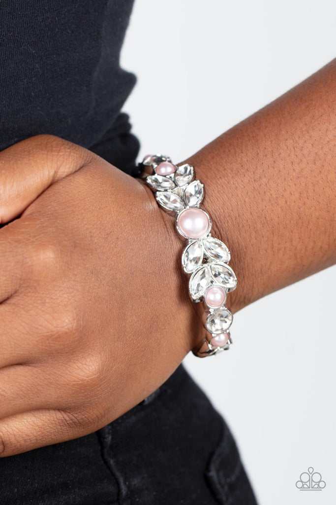Dotted with bubbly pink pearls, an oversized collection of round and marquise style white rhinestones boldly coalesce into a sparkly centerpiece that is flanked by stacks of leafy silver frames that gracefully curve into a decorative cuff.  Sold as one individual bracelet.  