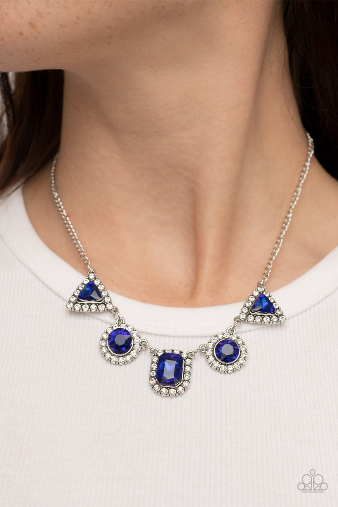 Featuring triangular, round, and emerald style cuts, a glittery collection of blue rhinestones are bordered in glassy white rhinestones as they delicately link below the collar for a sparkly statement. Features an adjustable clasp closure.  Sold as one individual necklace. Includes one pair of matching earrings.