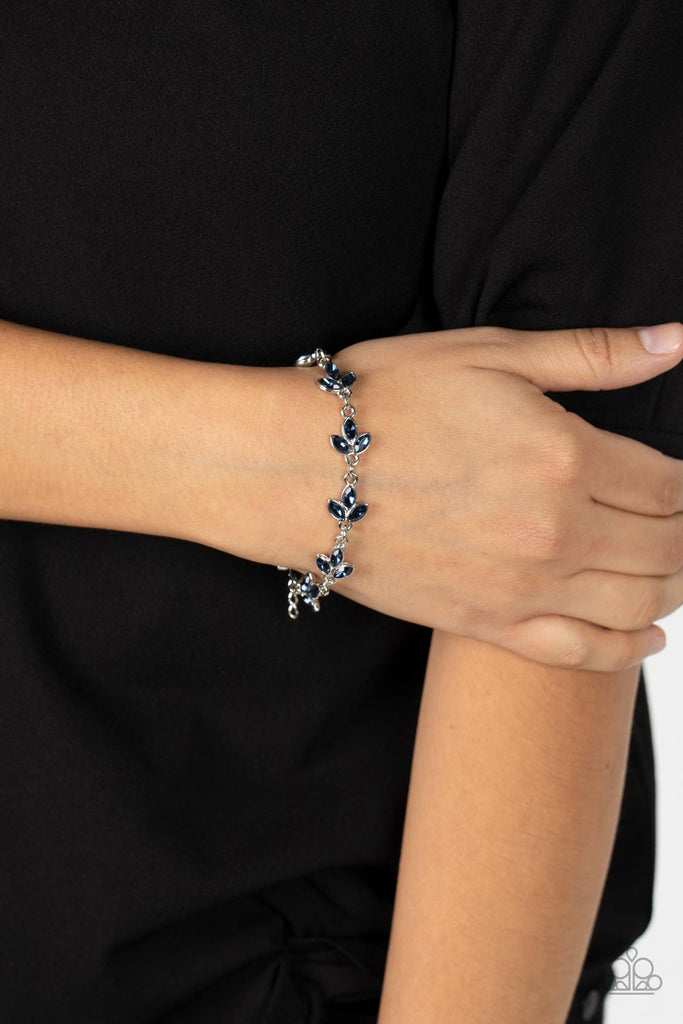 Twinkling trios of marquise cut blue rhinestones gather into leafy frames as they delicately link around the wrist, resulting in a radiant centerpiece. Features an adjustable clasp closure.  Sold as one individual bracelet.