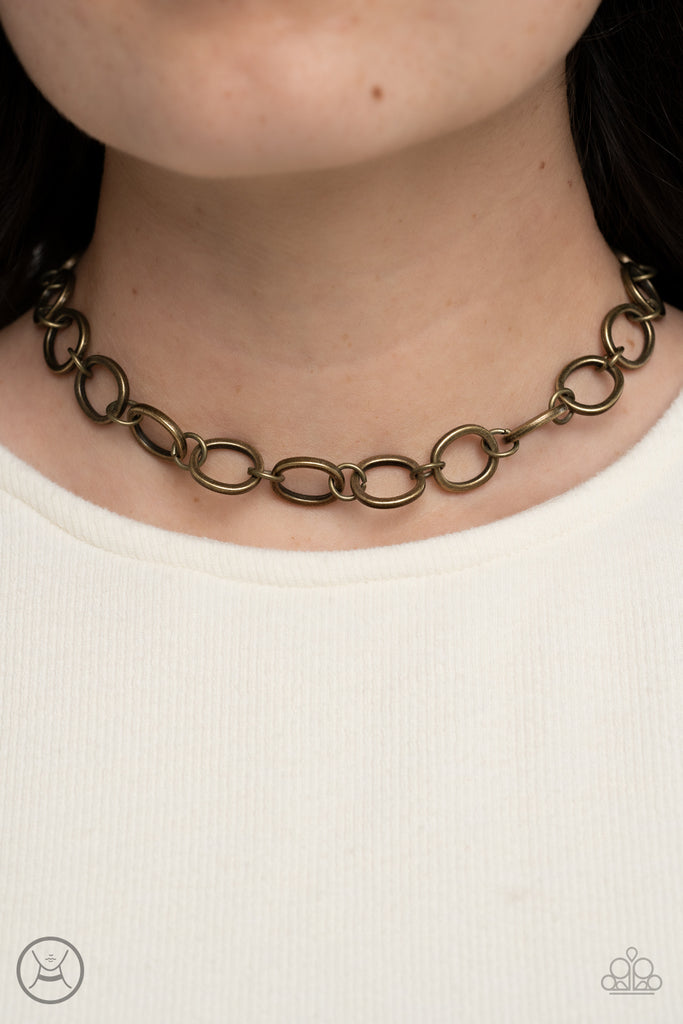 90s-nostalgia-brass  Brushed in an antiqued finish, imperfectly shaped circles link together for a gritty industrial statement. Features an adjustable clasp closure.  Sold as one individual choker necklace. Includes one pair of matching earrings.