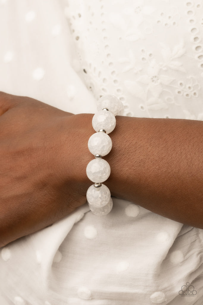 arctic-affluence-white  Infused with dainty silver accents, an oversized collection of crackly white glass-like beads are threaded along stretchy bands around the wrist for an icy look.  Sold as one individual bracelet.