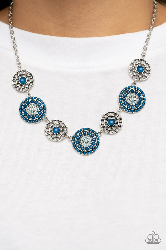 Bursts of faceted Mykonos Blue beads and sparkling opal blue rhinestones radiate from the centers of antiqued silver frames, while smaller airy frames are dotted with Mykonos Blue centers. The whimsical designs alternate around the collar making a dazzling display. Features an adjustable clasp closure.  Sold as one individual necklace. Includes one pair of matching earrings.