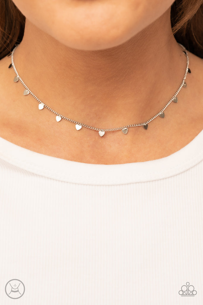 Dainty silver hearts dance from a dainty silver chain around the neck, creating a flirtatious fringe. Features an adjustable clasp closure.  Sold as one individual choker necklace. Includes one pair of matching earrings.