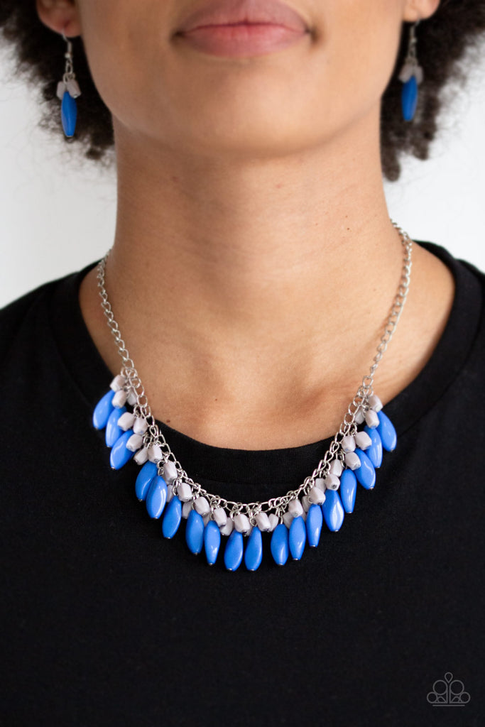 Varying in size and shape, imperfect blue and gray beads cascade from the bottom of a shimmery silver chain, creating a vivacious fringe below the collar. Features an adjustable clasp closure.  Sold as one individual necklace. Includes one pair of matching earrings.