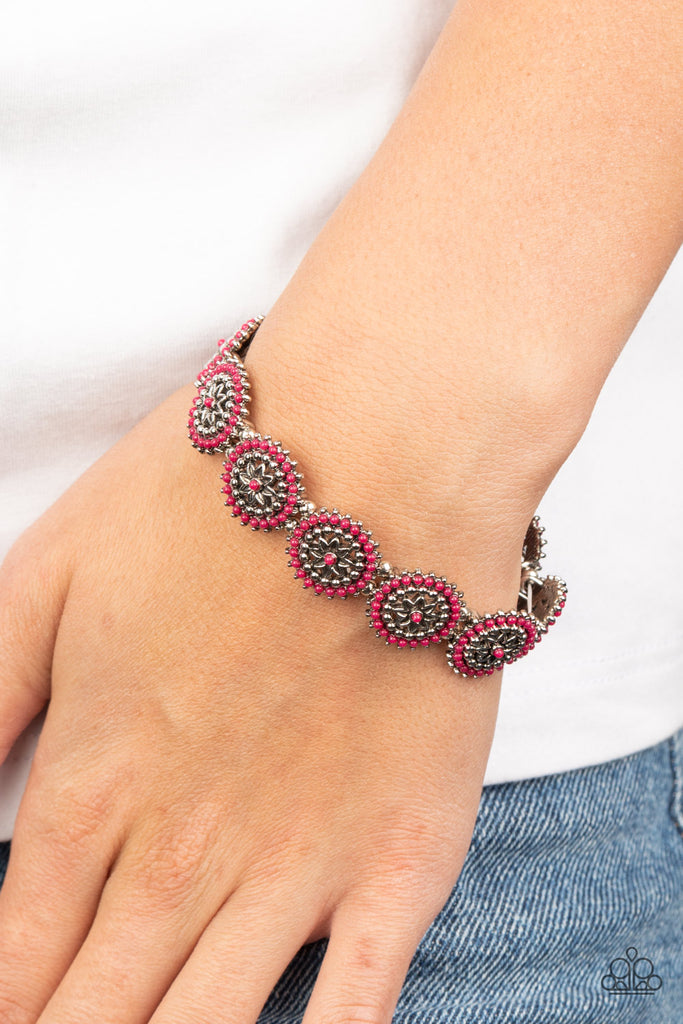 Dotted in dainty Pink Peacock beads, studded silver floral frames are delicately threaded along stretchy bands around the wrist for a whimsically seasonal look.  Sold as one individual bracelet.