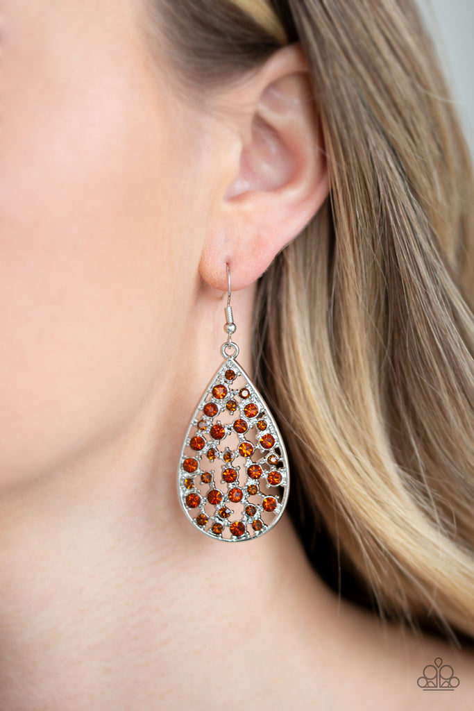 Hints of silver and glittery rhinestones collect inside an airy silver teardrop frame, creating a gorgeous lure. Earring attaches to a standard fishhook fitting.  Sold as one pair of earrings.