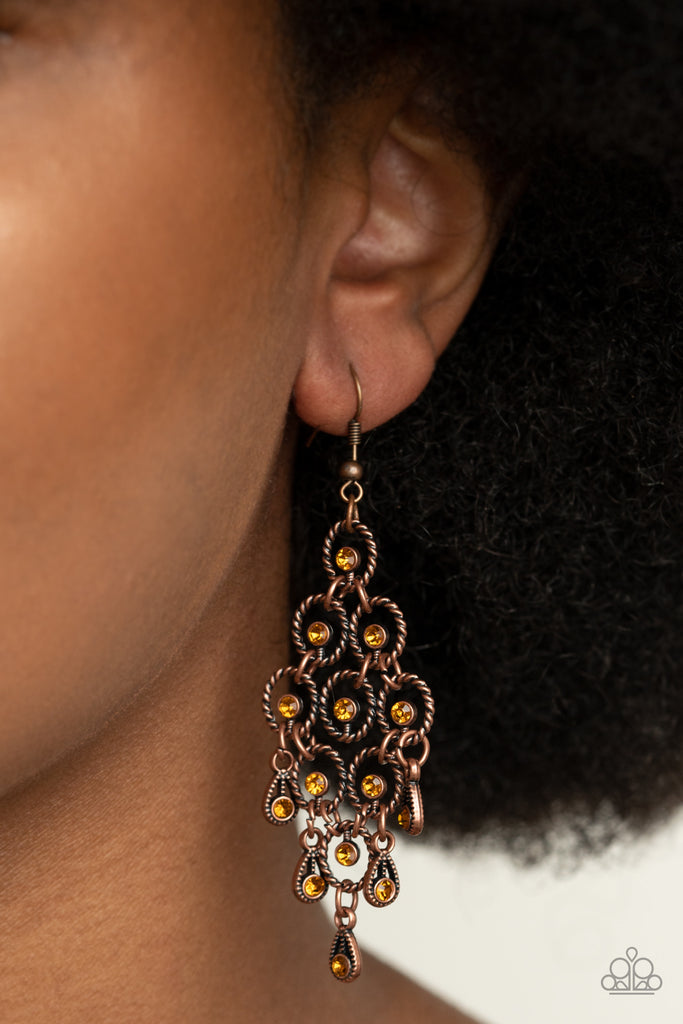 Dotted with glittery topaz rhinestones, an interlocking collection of oval rope-like copper frames gives way to a decorative fringe of shimmery copper teardrops. Earring attaches to a standard fishhook fitting.  Sold as one pair of earrings.
