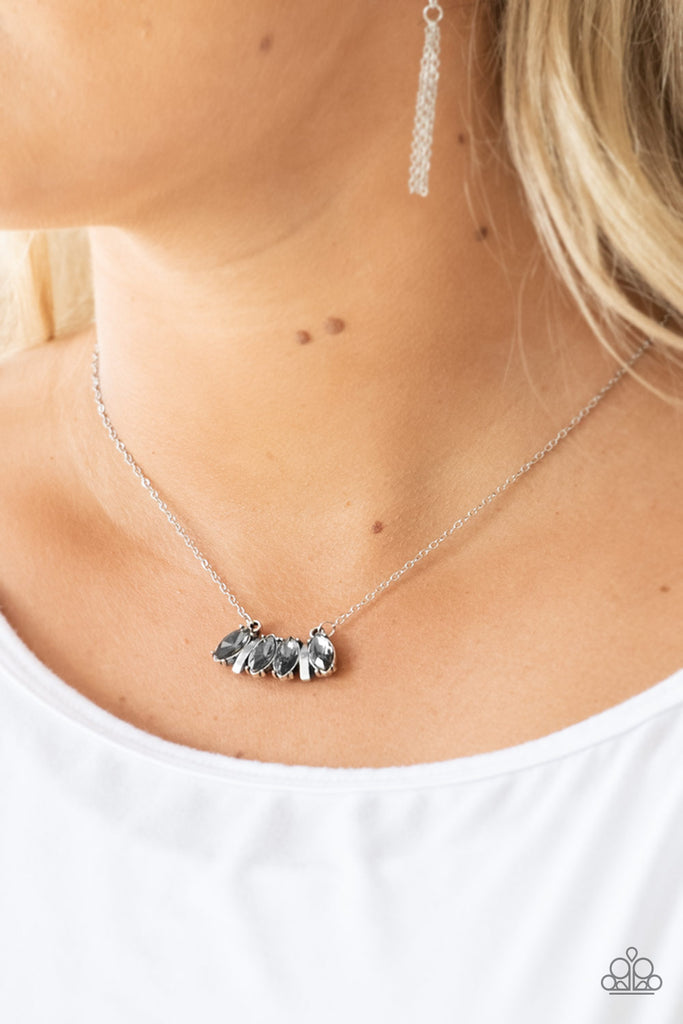 Featuring elegant marquise style cuts, smoky rhinestones join with silver accents below the collar, creating a dainty pendant. Features an adjustable clasp closure.  Sold as one individual necklace.  Includes one pair of matching earrings. 