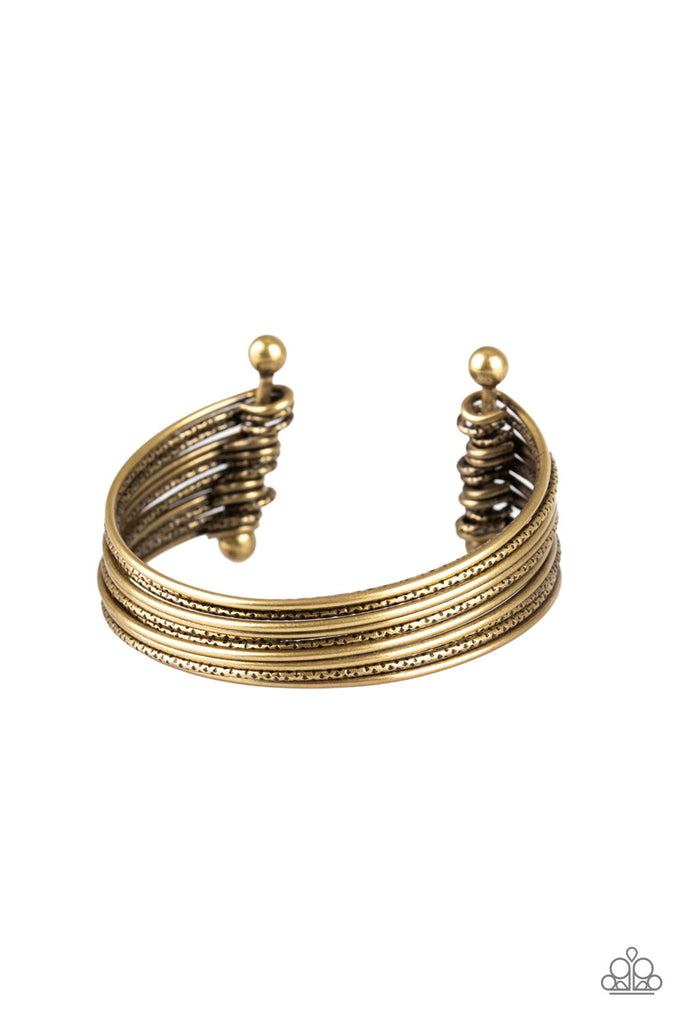Attached to two brass rods, smooth and textured brass bars curl around the wrist, creating the illusion of stacked bangles.  Sold as one individual bracelet.