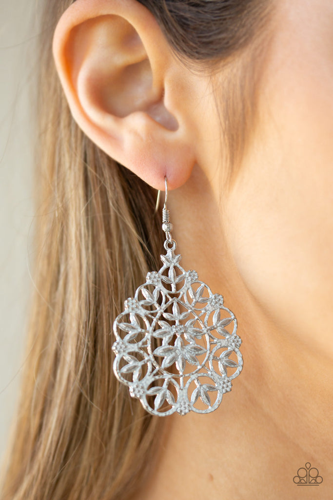 Brushed in a refreshing white finish, flowery filigree climbs a frilly silver teardrop frame for a whimsical look. Earring attaches to a standard fishhook fitting.  Sold as one pair of earrings.