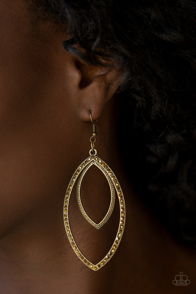 A shimmery brass frame swings from the top of a larger brass frame encrusted with glittery aurum rhinestones. Earring attaches to a standard fishhook fitting.  Sold as one pair of earrings.