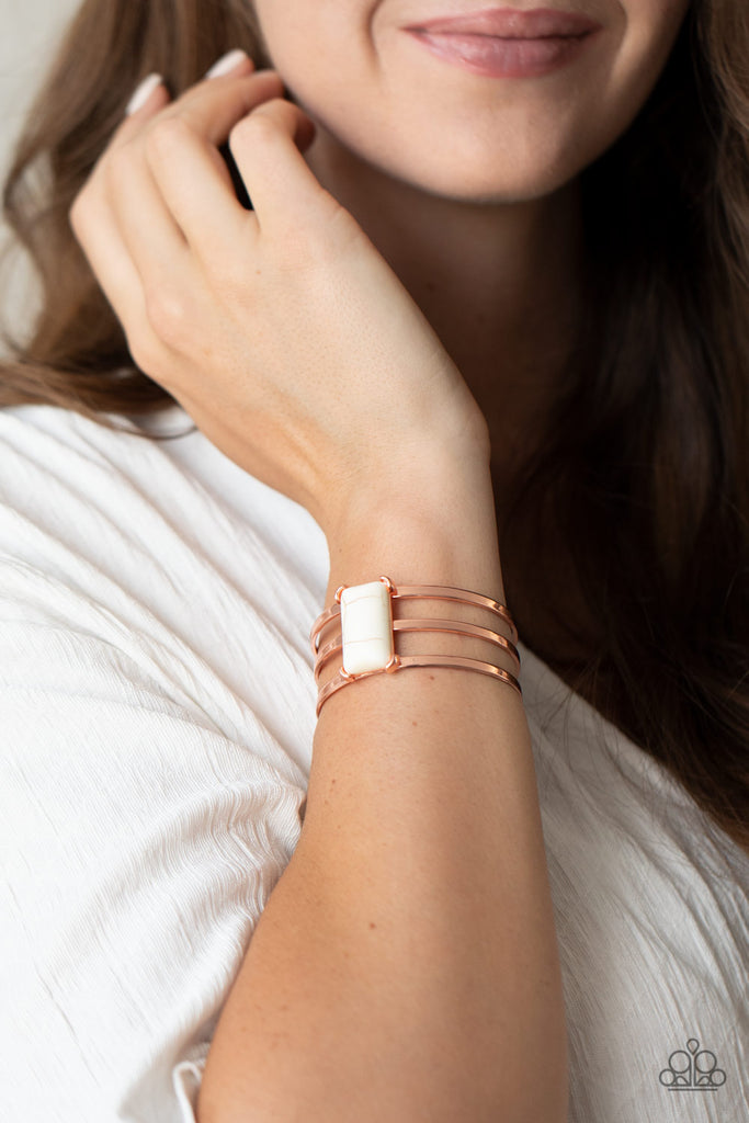 Chiseled into a sleek rectangle, a smooth white stone is pressed into the center of a copper layered cuff for a seasonal flair.  Sold as one individual bracelet.