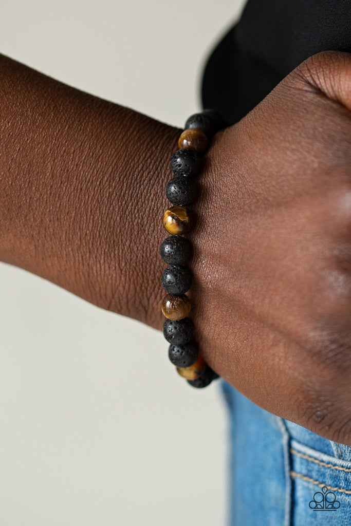 A collection of black lava rock and glassy Tiger's Eye stone beads are threaded along a stretchy band around the wrist for a seasonal look.  Sold as one individual bracelet.