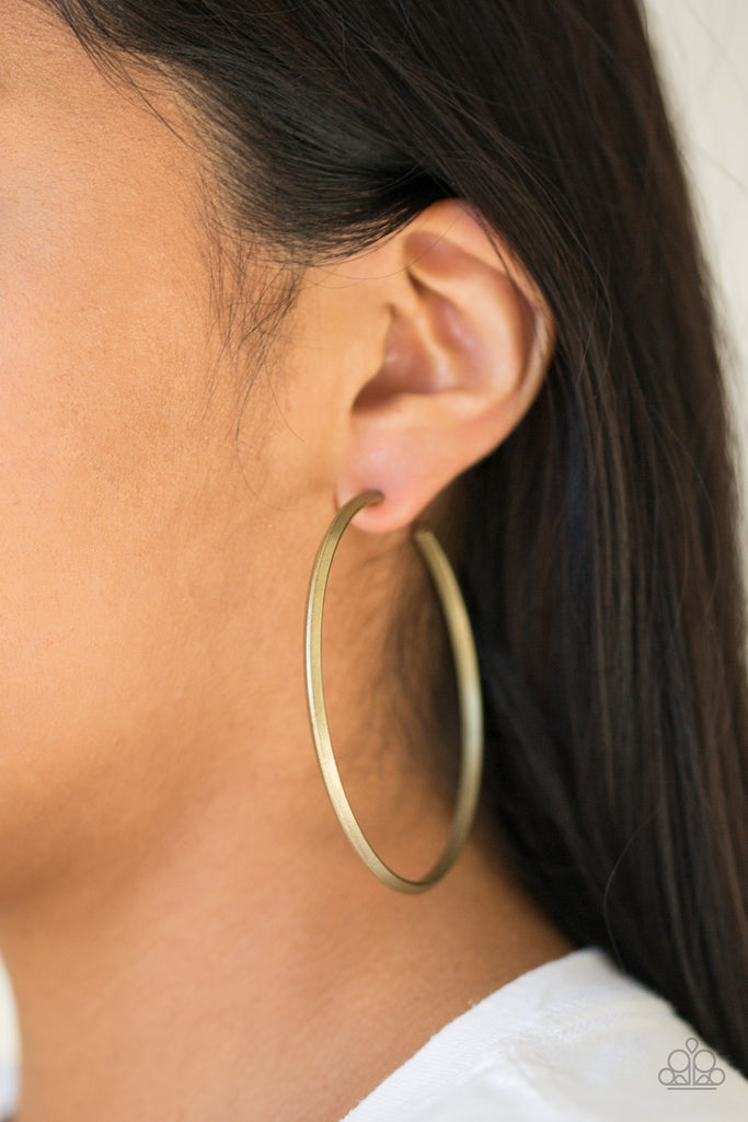 Brushed in an antiqued shimmer, a glistening brass bar curls into a sleek hoop for a classic look. Earring attaches to a standard post fitting. Hoop measures 2 1/2" in diameter.  Sold as one pair of hoop earrings.