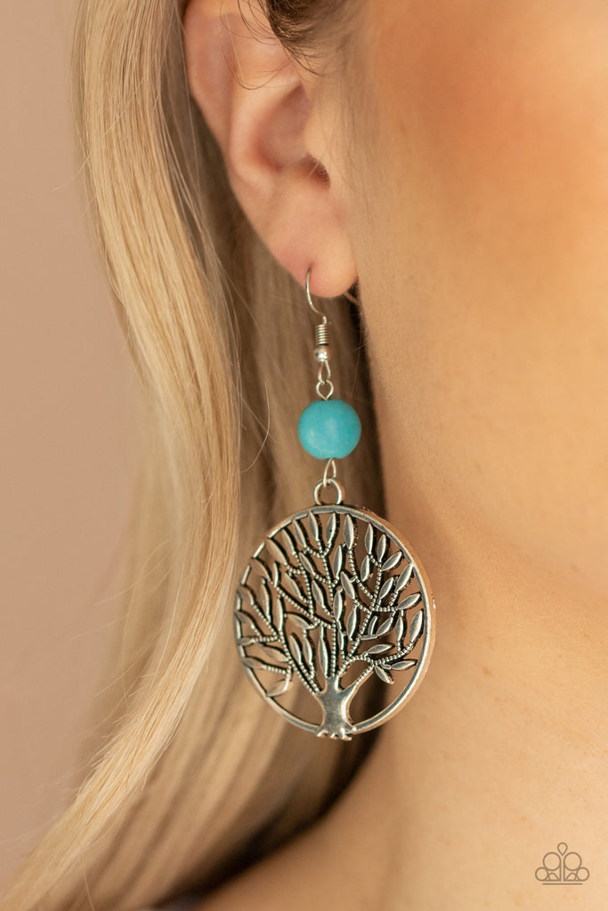 A shimmery silver tree frame swings from the bottom of a refreshing turquoise stone, creating an earthy lure. Earring attaches to a standard fishhook fitting.  Sold as one pair of earrings.