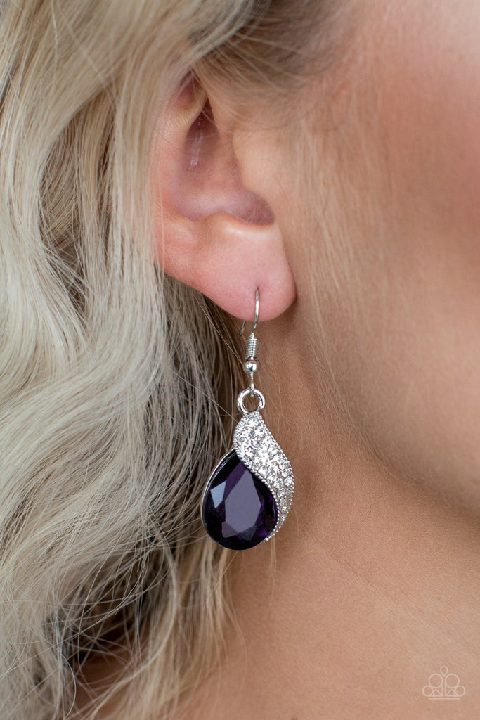 Encrusted in glittery white rhinestones, a shimmery silver ribbon wraps around a faceted purple teardrop gem for a timeless look. Earring attaches to a standard fishhook fitting.  Sold as one pair of earrings.
