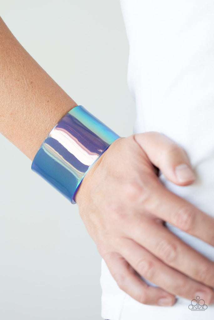 Featuring a holographic shimmer, a thick blue acrylic cuff wraps around the wrist for a retro inspired fashion.  Sold as one individual bracelet.