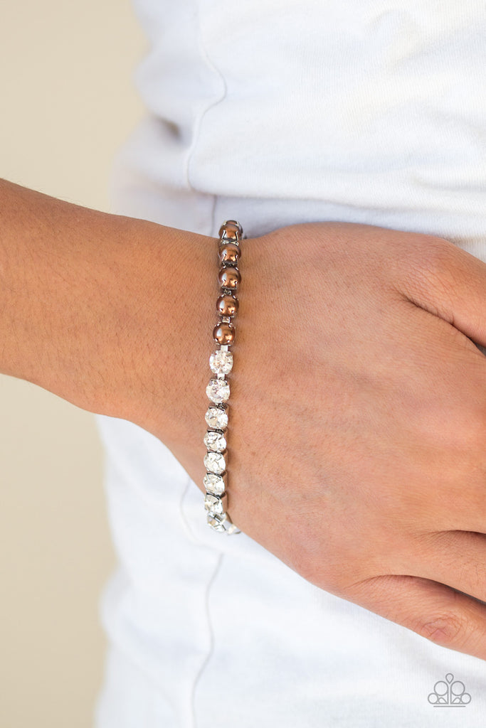 Featuring square silver fittings, a row of pearly brown beads connect with a row of glittery white rhinestones for a modern twist. Features an adjustable clasp closure.  Sold as one individual bracelet.