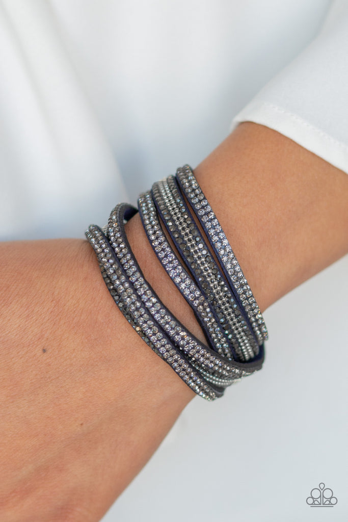 Rows of smoky and hematite rhinestones and strands of glistening silver ball chains race along three strands of blue suede for a sassy look. The elongated band allows for a trendy double wrap design. Features an adjustable bracelet.