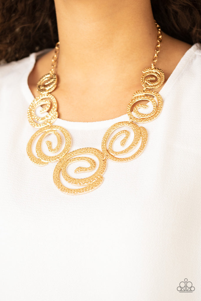 Gradually increasing in size, hammered gold swirls link below the collar for a statement-making finish. Features an adjustable clasp closure.  Sold as one individual necklace. Includes one pair of matching earrings.