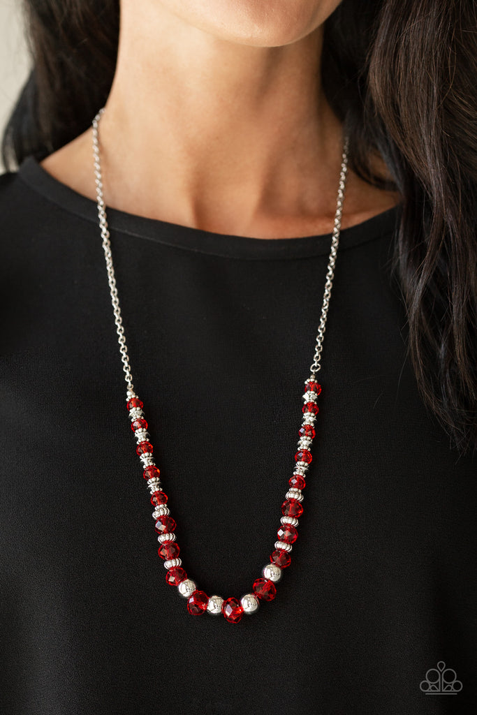 Varying in size, shiny silver beads, textured silver accents, and red crystal-like beads are threaded along an invisible wire at the bottom of a lengthened silver chain for a refined flair. Features an adjustable clasp closure.  Sold as one individual necklace. Includes one pair of matching earrings.