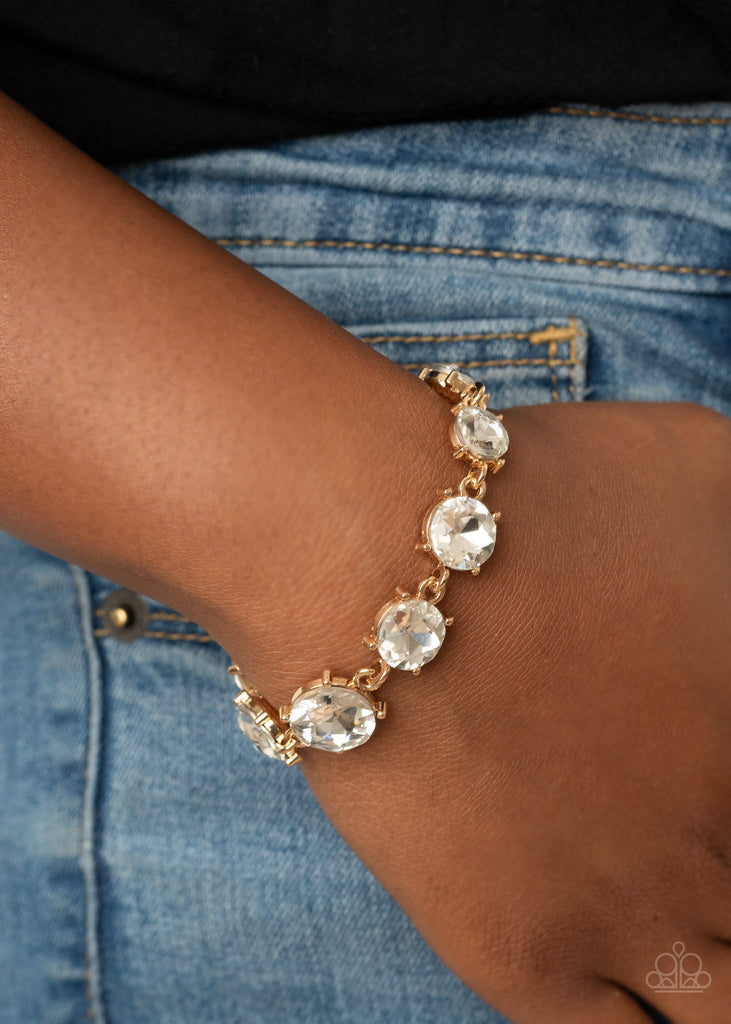 Gradually increasing in size at the center, a dramatic row of exaggerated white rhinestone encrusted gold frames delicately link around the wrist for a statement-making sparkle. Features an adjustable clasp closure.  Sold as one individual bracelet.