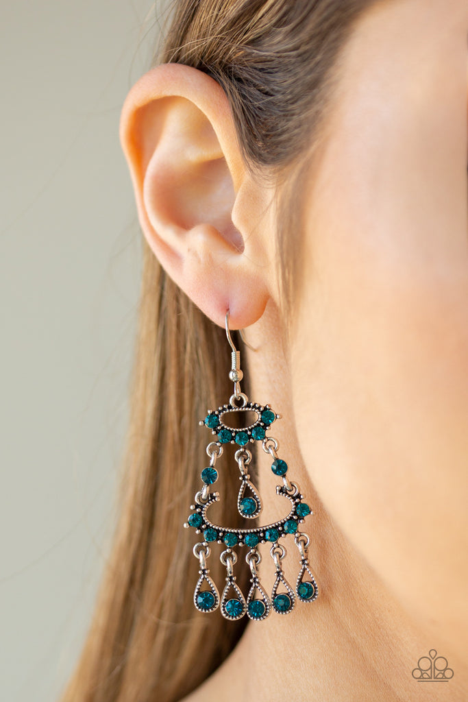 Dotted in dainty blue rhinestones, stacked silver frames give way to a teardrop fringe encrusted in glassy blue rhinestones, creating a refined chandelier. Earring attaches to a standard fishhook fitting.  Sold as one pair of earrings.