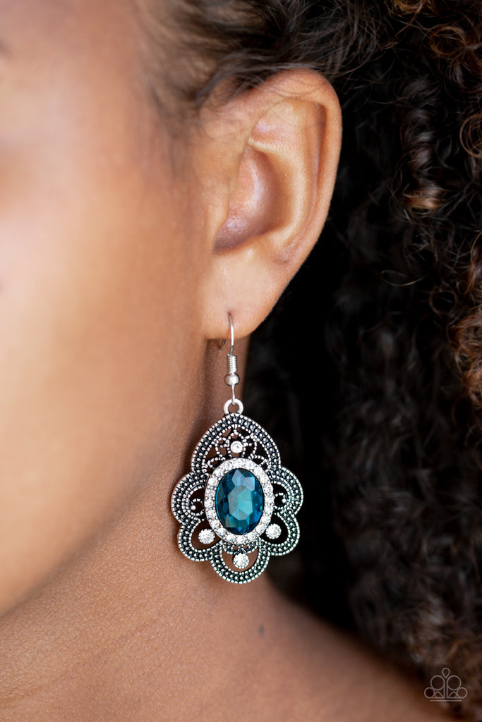 Radiating with studded detail, antiqued silver petals flare from a white and blue rhinestone encrusted center for a regal look. Earring attaches to a standard fishhook fitting.  Sold as one pair of earrings.