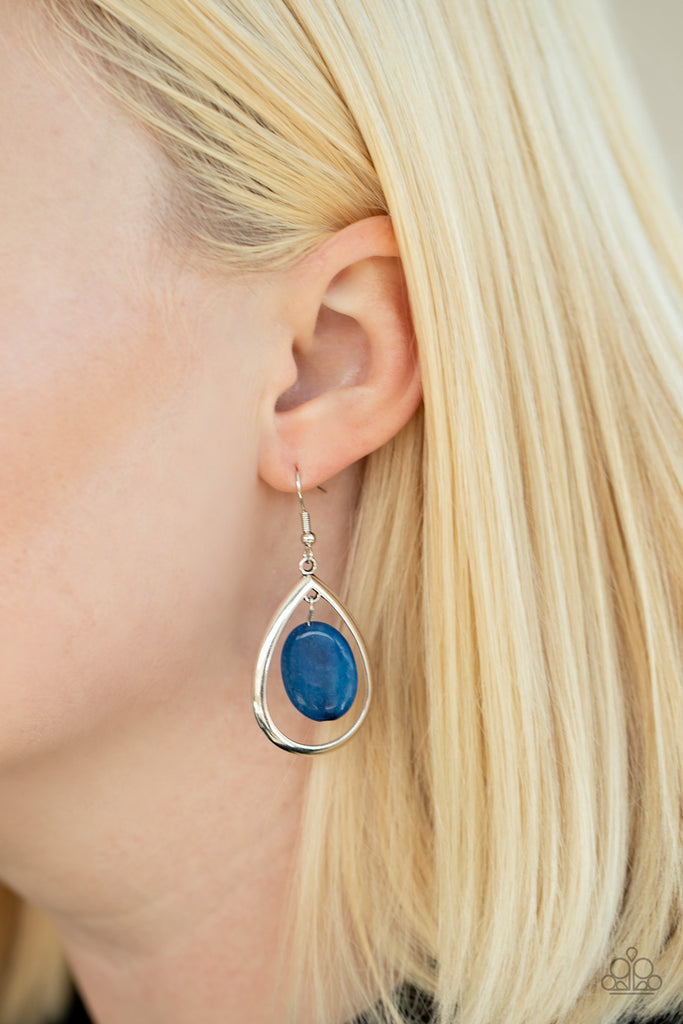 An oval blue stone swings from the bottom of an antiqued silver teardrop frame, creating a seasonal lure. Earring attaches to a standard fishhook fitting. As the stone elements in this piece are natural, some color variation is normal.  Sold as one pair of earrings.