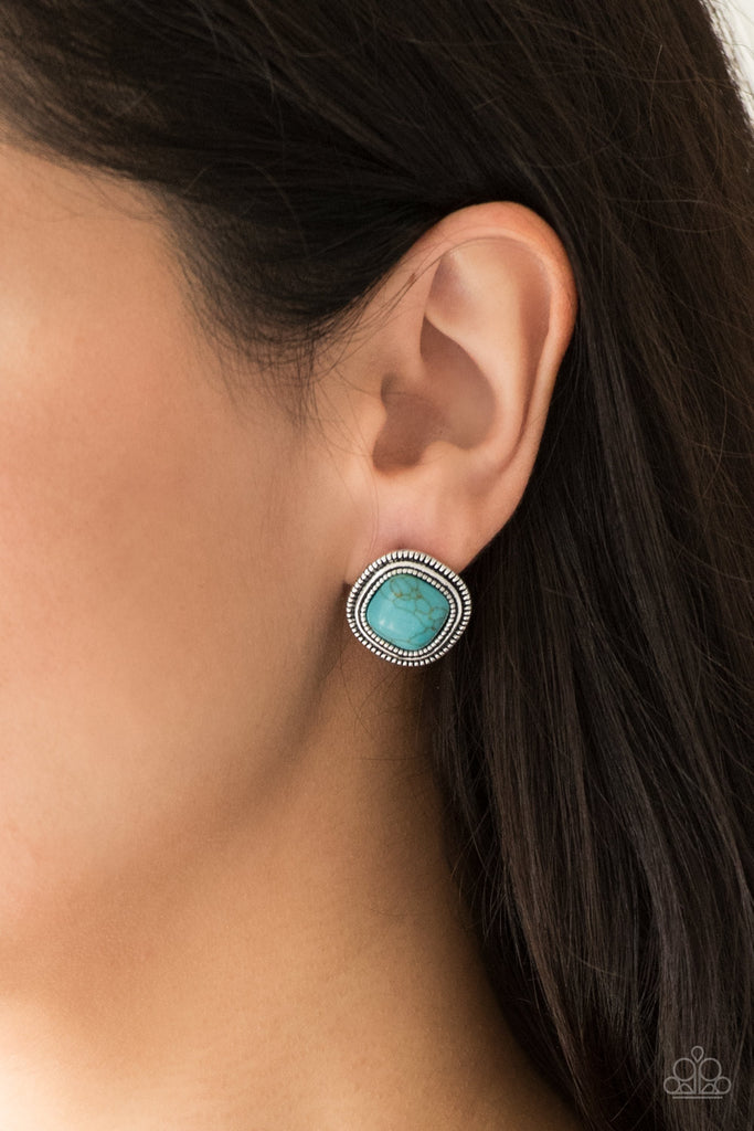 Chiseled into a tranquil square, a refreshing turquoise stone is pressed into a studded silver frame for a seasonal look. Earring attaches to a standard post fitting.  Sold as one pair of post earrings.