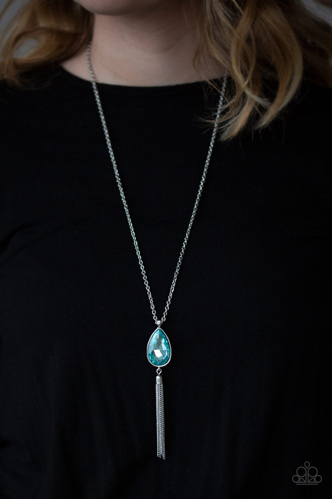 A blue teardrop gem swings from the bottom of a lengthened silver chain for a dramatic look. A shimmery silver chain tassel swings from the bottom of the pendant for a glamorous finish. Features an adjustable clasp closure.  Sold as one individual necklace. Includes one pair of matching earrings.