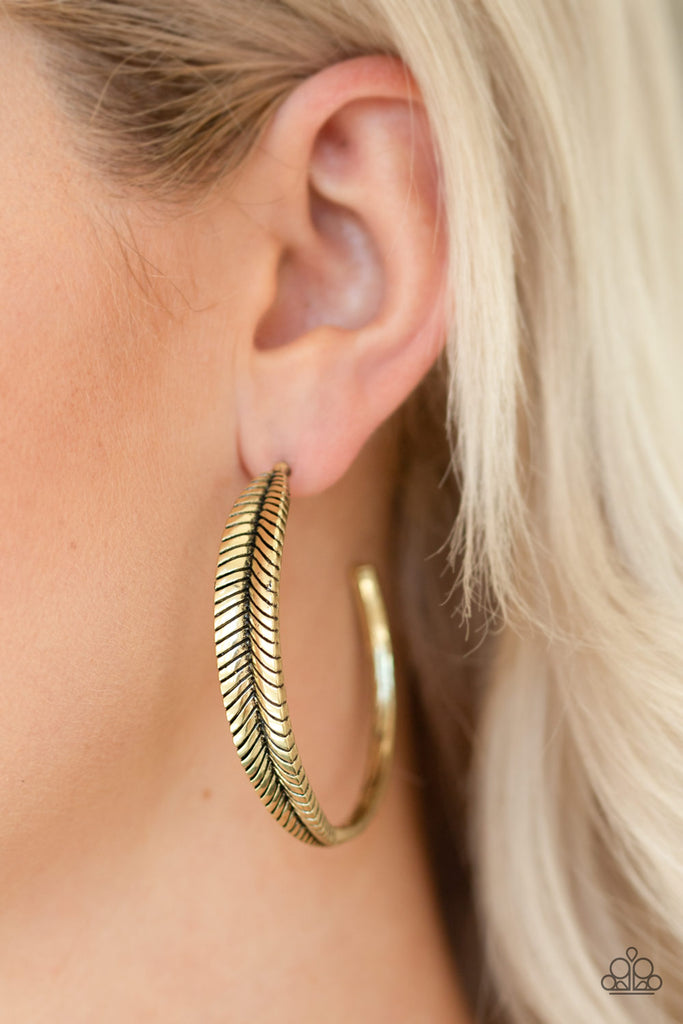 Featuring lifelike textures, a glistening brass feather hoop curls around the ear for a seasonal look. Earring attaches to a standard post fitting. Hoop measures 2" in diameter.  Sold as one pair of hoop earrings.