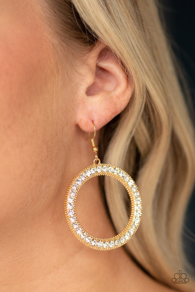 Encrusted in a glittery ring of white rhinestones, a studded gold hoop swings from the ear for a dramatic look. Earring attaches to a standard fishhook fitting.  Sold as one pair of earrings.