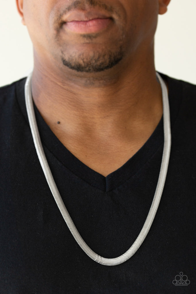 Featuring a high-sheen finish, a thick silver herringbone chain drapes across the chest for a sleek, upscale look. Features an adjustable clasp closure.  Sold as one individual necklace.