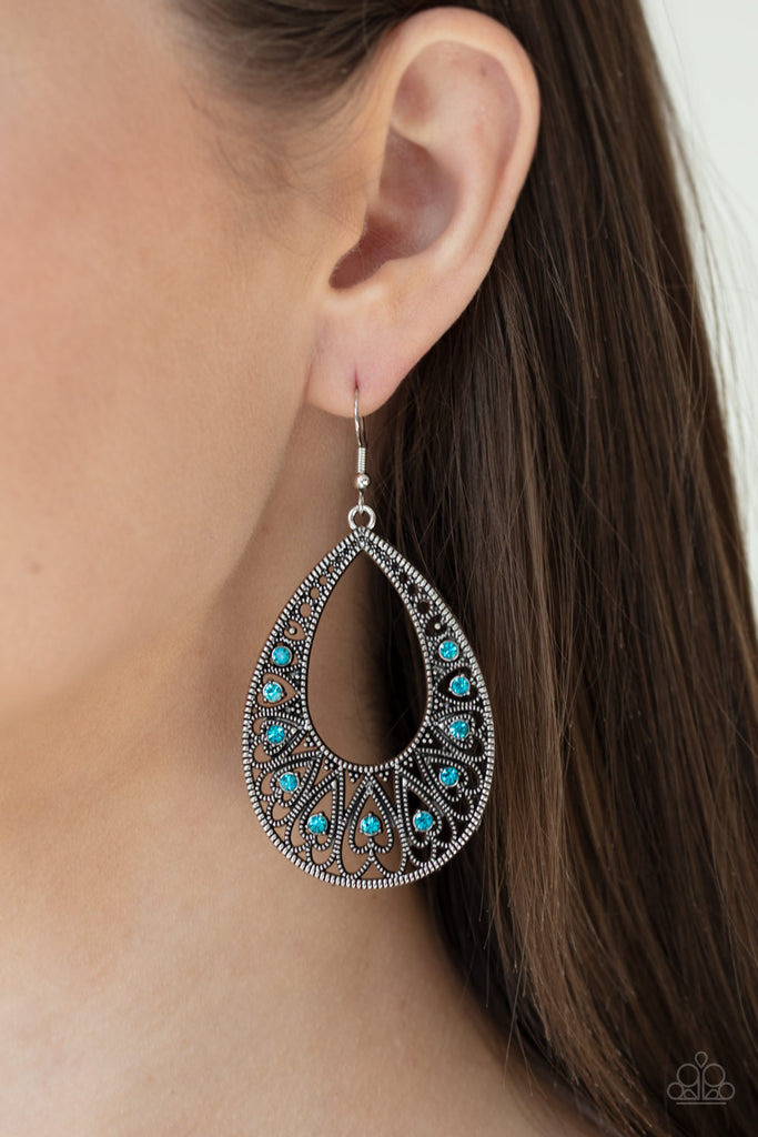 Dotted with dainty blue rhinestone centers, studded silver heart frames fan out into a shiny silver teardrop frame for a lovable look. Earring attaches to a standard fishhook fitting.  Sold as one pair of earrings.