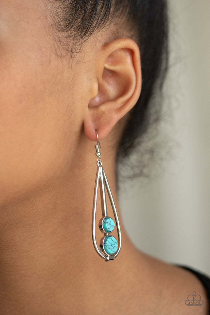 Featuring a faux marble finish, smooth turquoise stones are stacked in an airy silver teardrop frame for a seasonal flair. Earring attaches to a standard fishhook fitting.  Sold as one pair of earrings.