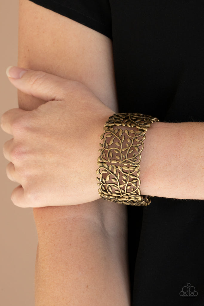 Brushed in an antiqued shimmer, leafy brass filigree frames are threaded along stretchy bands around the wrist for a vintage inspired look.  Sold as one individual bracelet.
