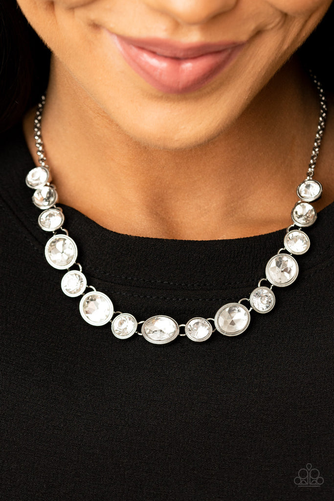 Encased in sleek silver frames, oval and round white rhinestones alternate below the collar for a timeless look. Features an adjustable clasp closure.  Sold as one individual necklace. Includes one pair of matching earrings.