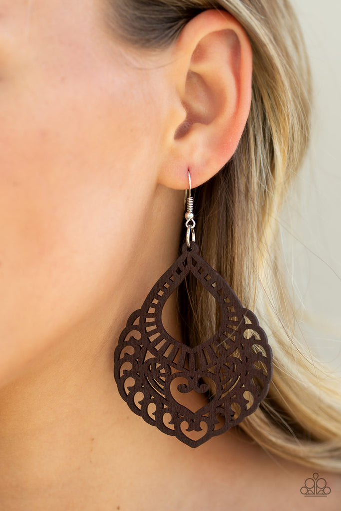 Painted in a rich brown finish, an airy wooden frame swirling with filigree detail swings from the ear for a seasonal look. Earring attaches to a standard fishhook fitting.  Sold as one pair of earrings.