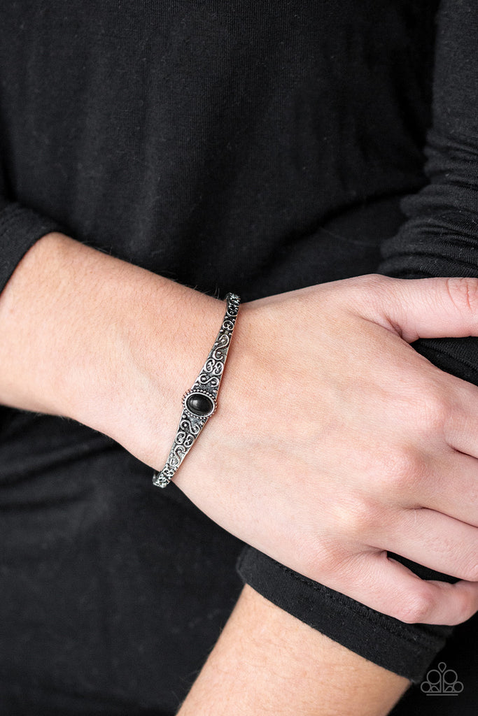 Infused with an earthy black stone center, a dainty silver cuff has been embossed in swirling antiqued detail for a seasonal look.  Sold as one individual bracelet.