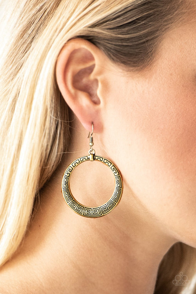 Brushed in an antiqued shimmer, a glistening brass hoop is stamped in dizzying patterns for a tribal inspired look. Earring attaches to a standard fishhook fitting.  Sold as one pair of earrings.