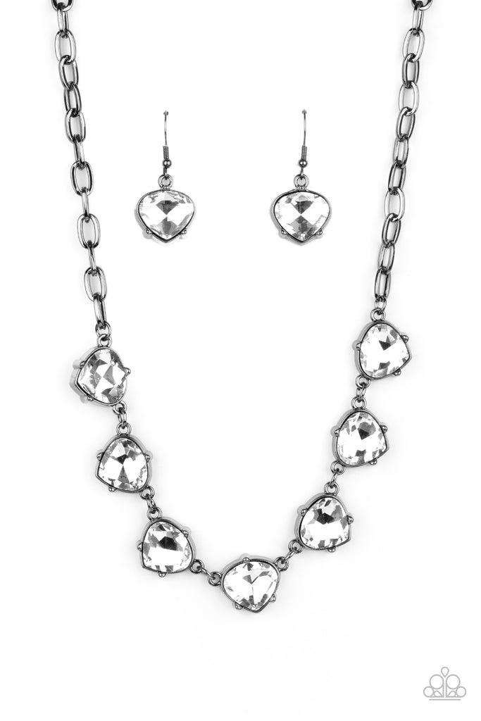 Attached to a sleek gunmetal chain, faceted white rhinestones teardrop frames delicately connect below the collar for an edgy glamorous look. Features an adjustable clasp closure.  Sold as one individual necklace. Includes one pair of matching earrings.