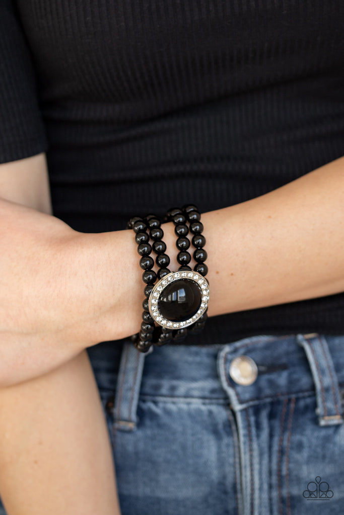 Threaded along stretchy bands, row after row of black beads are held in place by an exaggerated black beaded frame encrusted in glassy white rhinestones for a refined finish.  Sold as one individual bracelet.